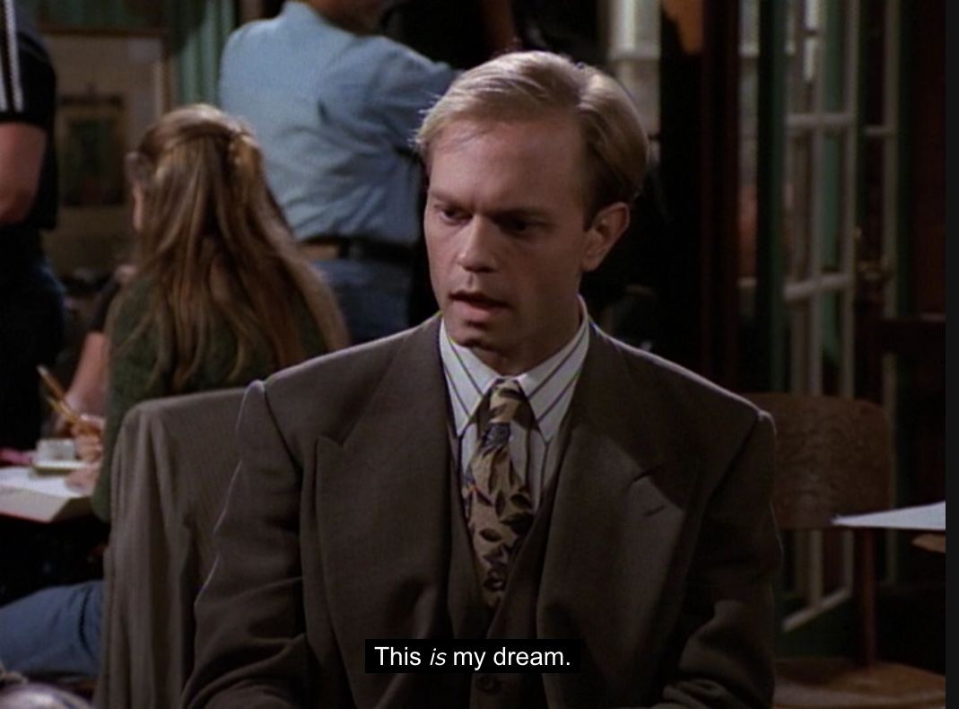 Description: The image is a still from the television show Frasier, depicting a scene in a restaurant. The main focus is on a man sitting at a table, wearing a suit and tie. He has a serious expression on his face, and the text overlaid on the image says, "This is my dream."

Disclaimer: I'm listening, caller, but before we proceed, I must offer this small caveat: The description of the image in question has been generated by an automated process, not unlike the way my brother Niles generates excuses to avoid physical exertion. As such, its accuracy may be as questionable as Dad's choice in recliners. Please, do exercise your own judgment, much as I do when selecting a fine sherry.