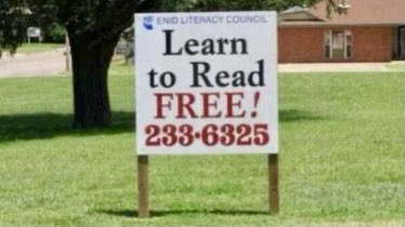 Lawn sign from Enid Literacy Council reads “Learn to Read FREE!” Followed by a phone number.